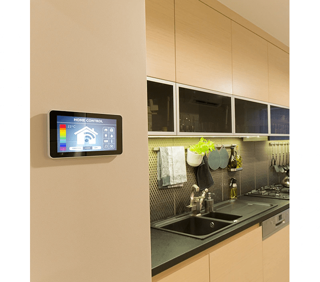 A kitchen with a tablet on the wall
